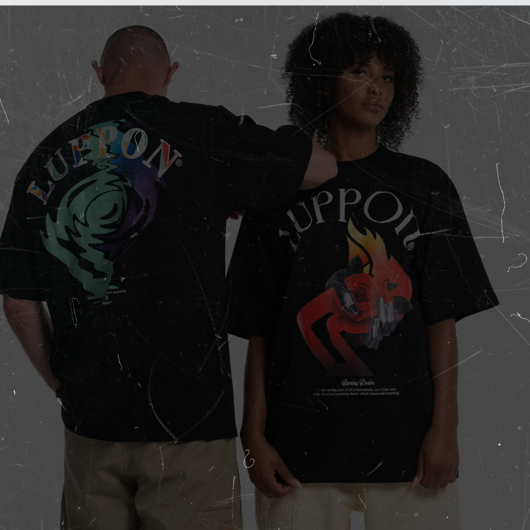 Two people wearing black t-shirts with colorful graphics on a dark background